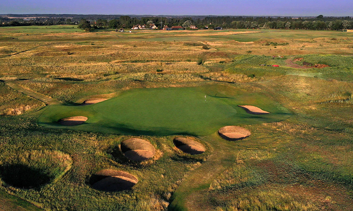 The 16th green surrounded by bunkers